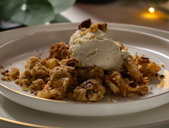 Baked apple crumble with cardamom, nuts & ice cream
