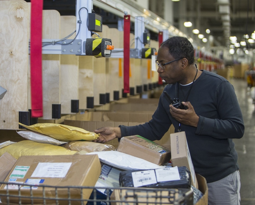 Postal Service employees perform spot checks to ensure packages are properly handled and sorted.