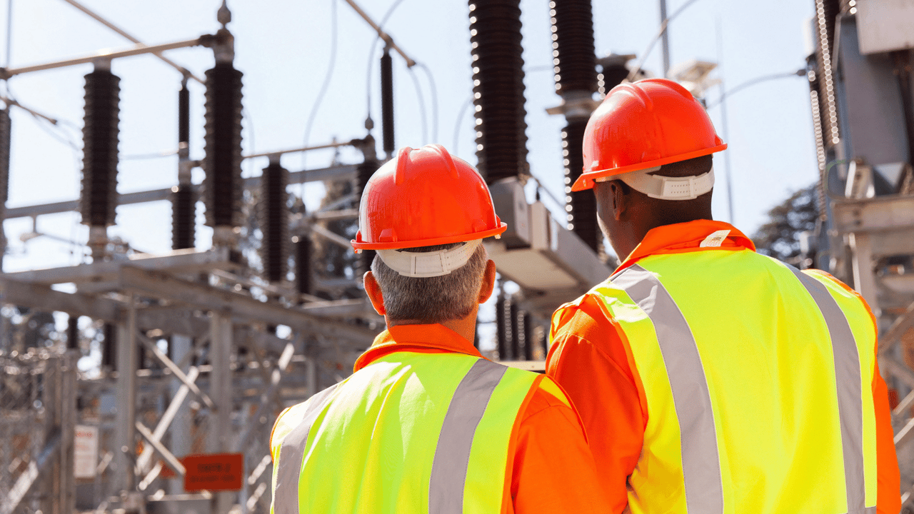 back view of two electrical engineers in substation back view of two electrical engineers in substation