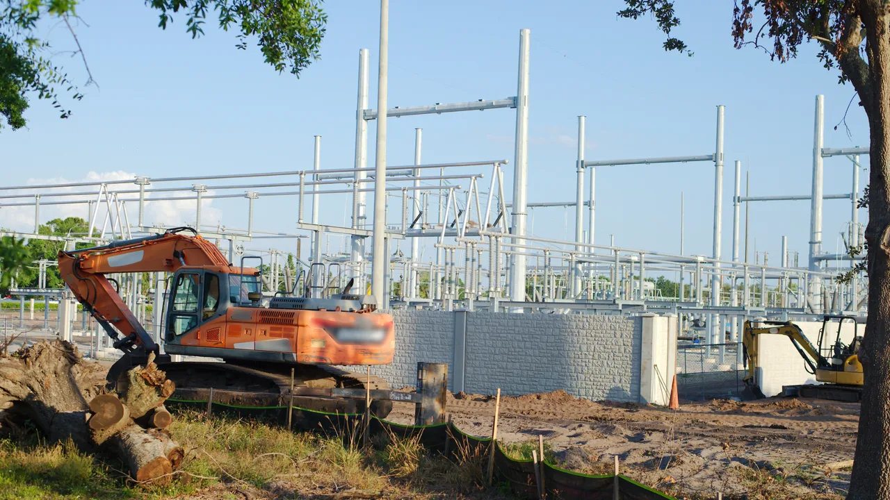 Development of an electrical station with visible structures, equipment, fence and land preparation with machinery Development of an electrical station with visible structures, equipment, fence and land preparation with machinery