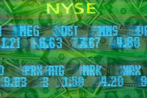 New York Stock Exchange stock trading board listings moving across US dollar bills.
