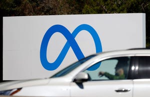 A car drives by a new logo and the name 'Meta' on the sign in front of Facebook headquarters on October 28, 2021