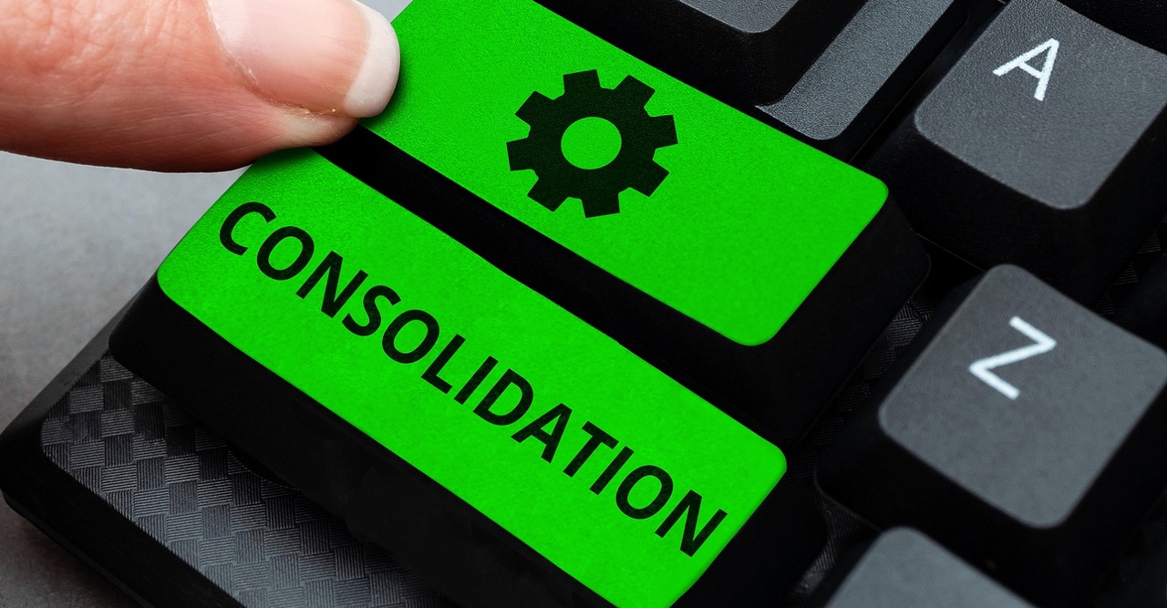 finger pressing "consolidation" button on keyboard finger pressing "consolidation" button on keyboard