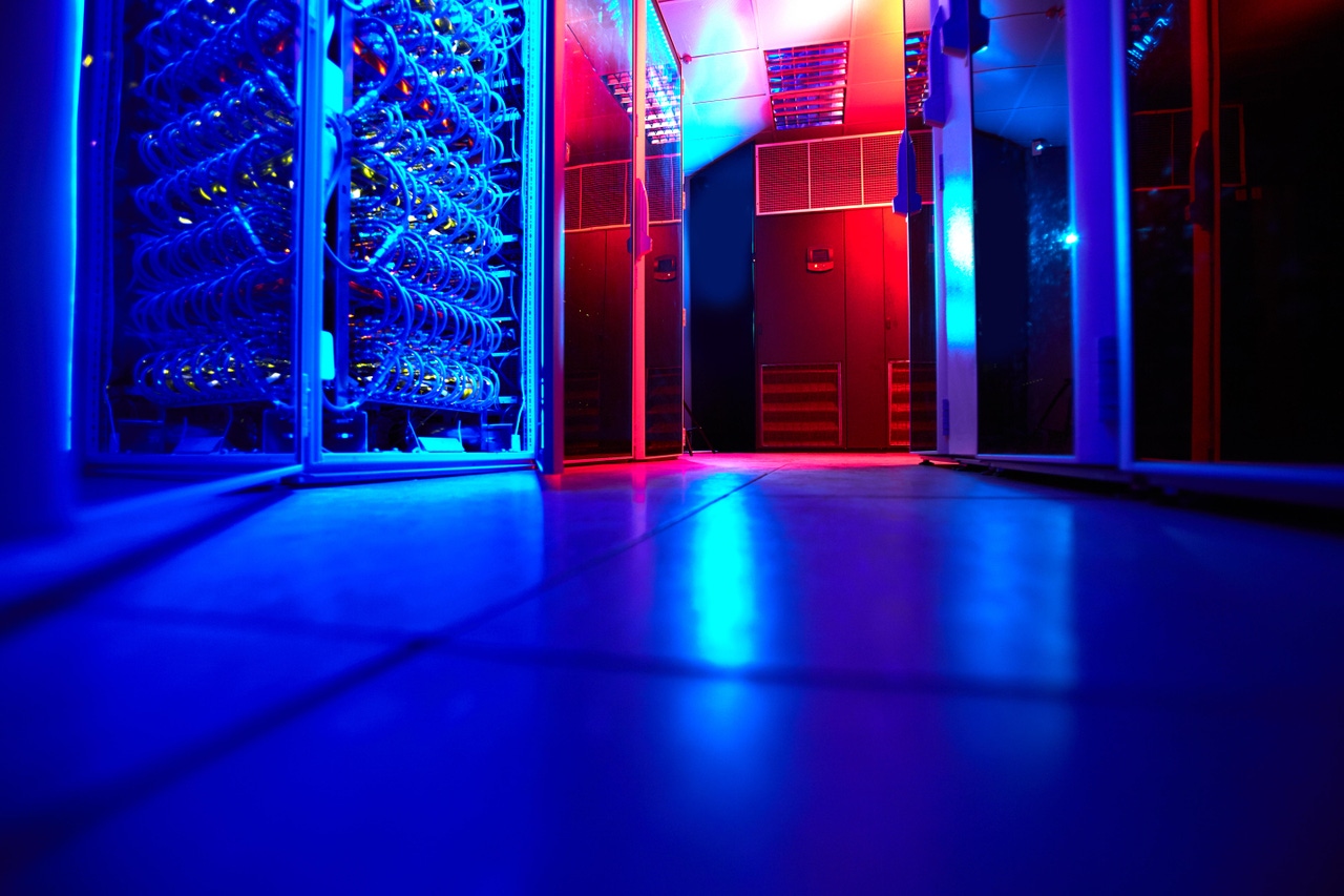 Data center server room with blue and red lighting. Data center server room with blue and red lighting.