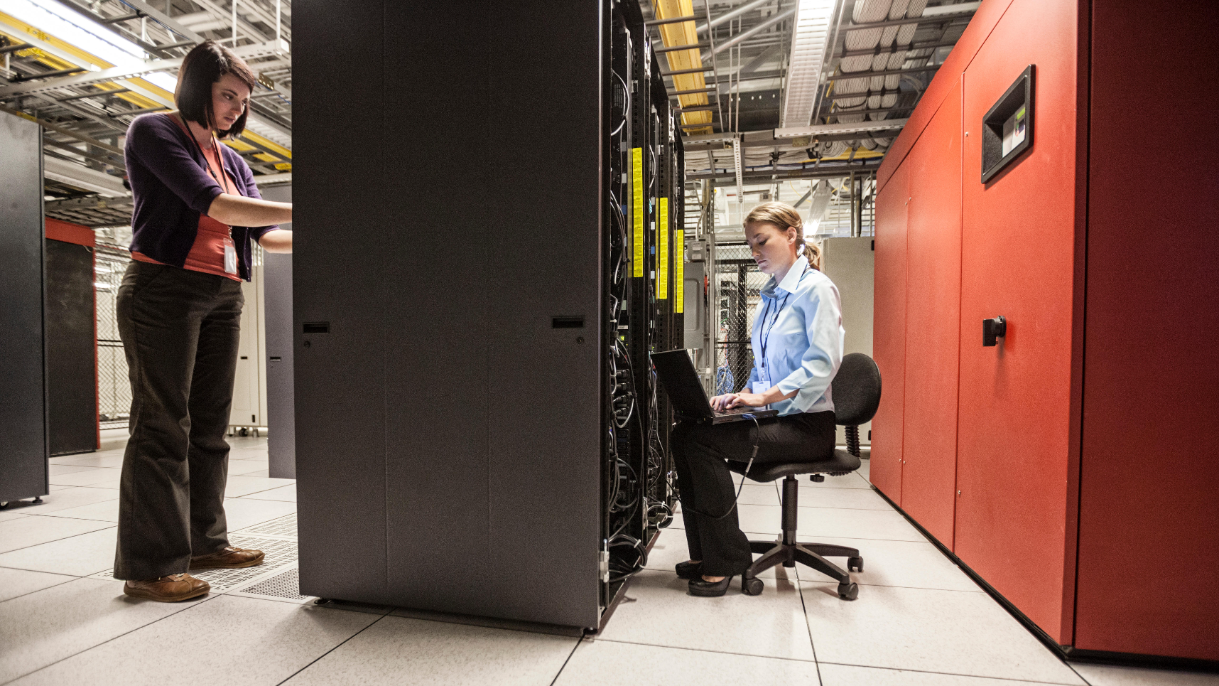 women technicians working on computer servers in a server farm