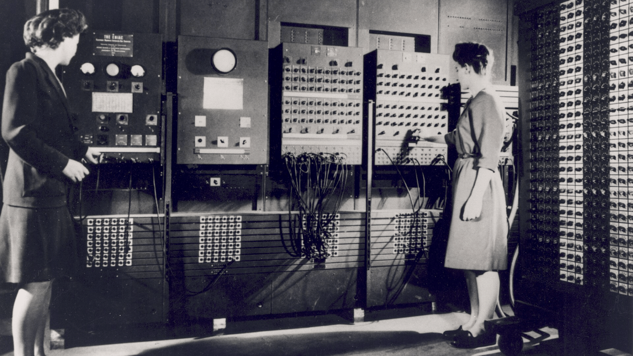 historical photo of two people operating ENIAC historical photo of two people operating ENIAC