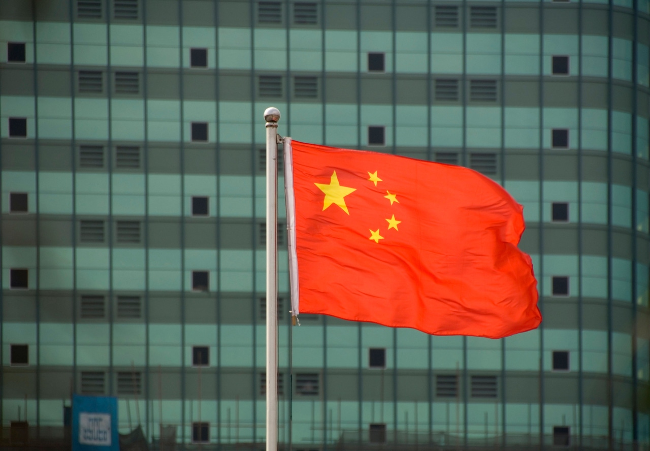 Chinese flag in front of building Chinese flag in front of building