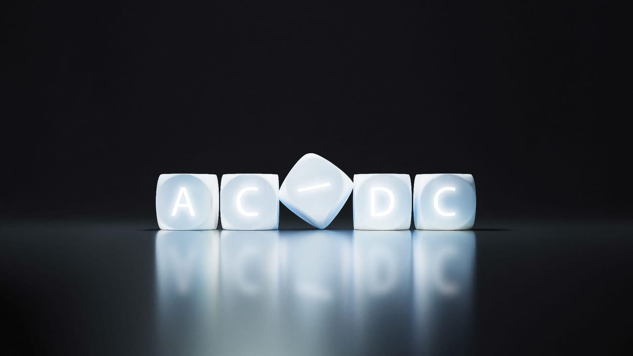 Lightbox, backlit letter cubes with AD/DC sign on black background Lightbox, backlit letter cubes with AD/DC sign on black background