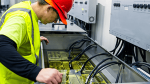 Technician Inspecting Server in Immersion Cooling Tank Technician Inspecting Server in Immersion Cooling Tank