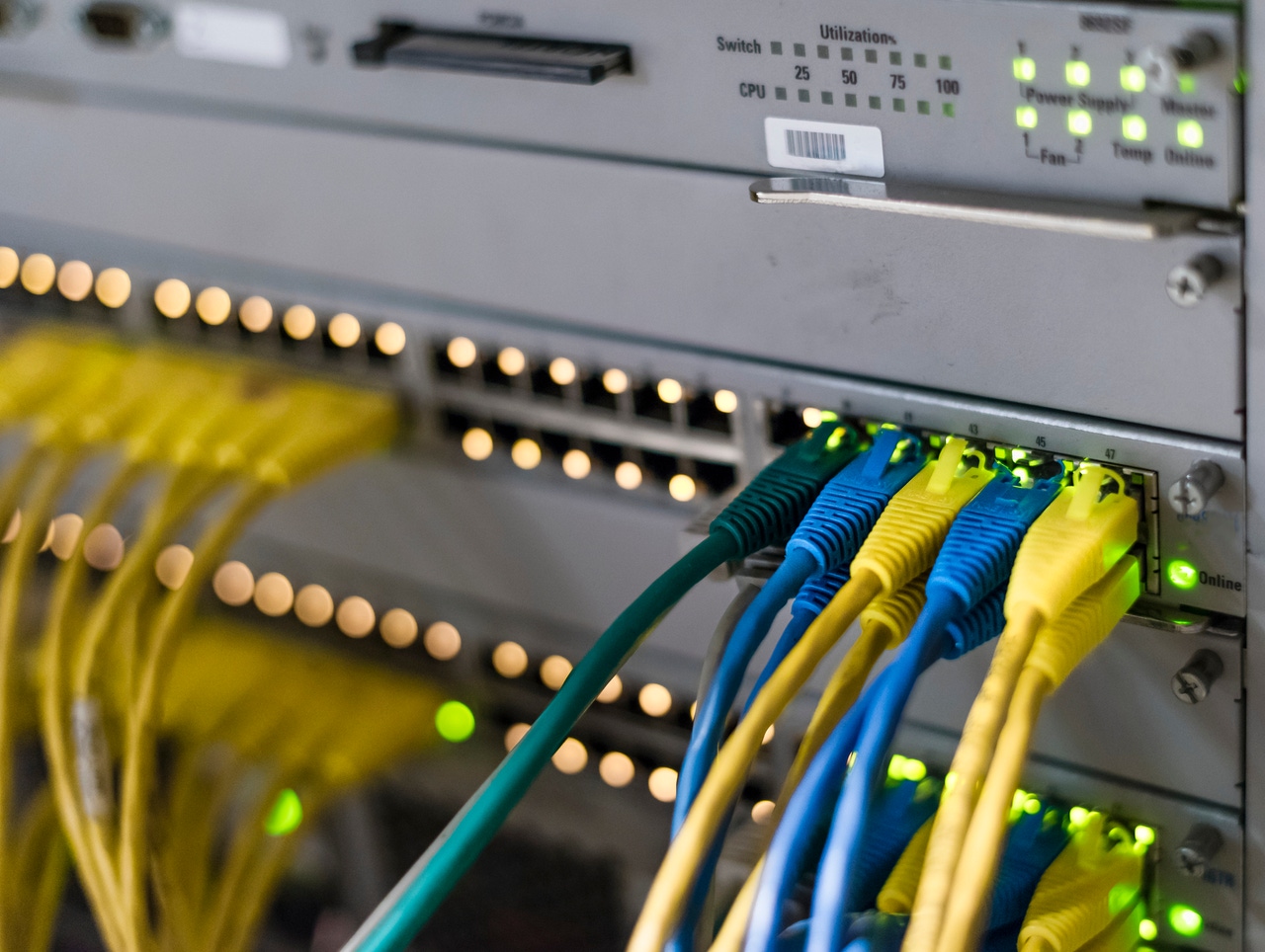 Computer network router / switch with several connected colourful LAN cables Computer network router / switch with several connected colourful LAN cables