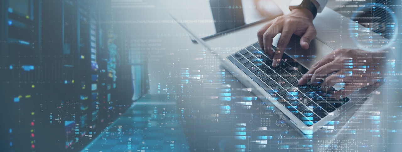 person typing on keyboard with technology visuals person typing on keyboard with technology visuals