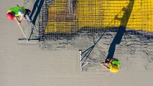 construction workers leveling concrete flooring construction workers leveling concrete flooring