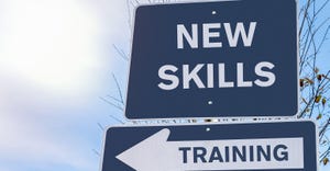 "New Skills" sign on top of "Training" sign "New Skills" sign on top of "Training" sign
