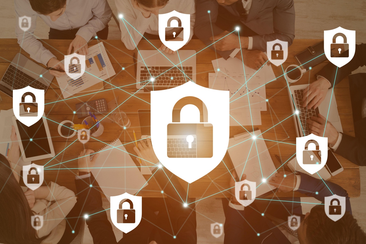 cybersecurity padlock icons overlayed on a company meeting cybersecurity padlock icons overlayed on a company meeting