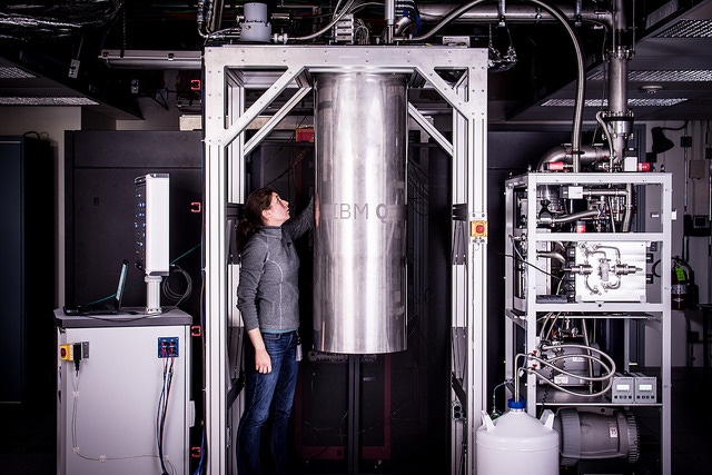 IBM Research Staff Member Katie Pooley is examining a cryostat with the new prototype of a commercial quantum processor inside.