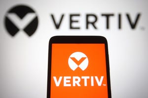 In this photo illustration, Vertiv Holdings Co logo is seen displayed on a smartphone and a pc screen.