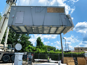 A self-contained Vapor Edge Module (VEM) being craned onto a concrete pad in Pittsburgh