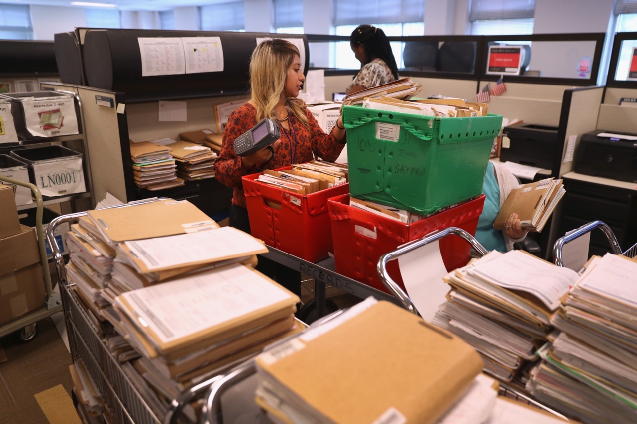 piles of paperwork in an office piles of paperwork in an office