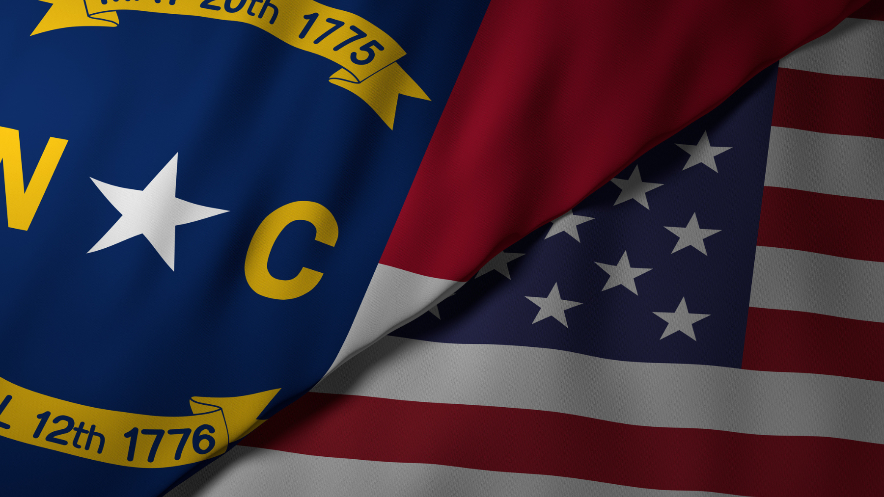 Close-up view of the North Carolina state flag alongside the United States national flag