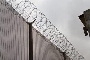 High security fence with barbed wire.