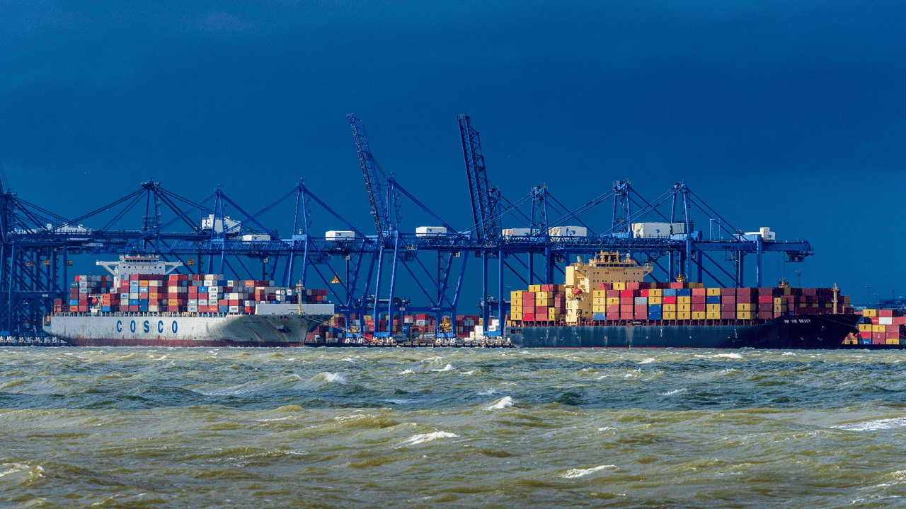 ship containers being unloaded at a port ship containers being unloaded at a port