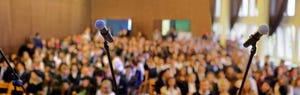 Blurred background of public event exhibition hall show concept with microphones