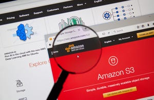 Amazon Web Services homepage through magnifying glass. AWS is a secure cloud services platform, offering compute power, database storage.