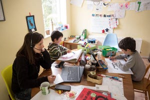 A Marsden, England, regional council employee works from home as her children study in March 2020.