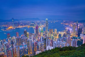 Image of Hong Kong with many skyscrapers during twilight blue hour.