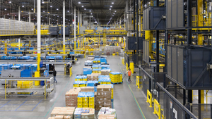 Workers prepare packages at an Amazon Fulfillment center