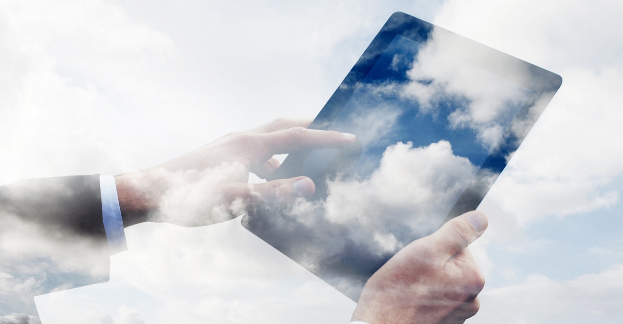 worker using tablet filled with clouds worker using tablet filled with clouds