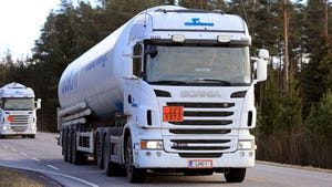 Two white trucks transport LNG on highway in South of Finland 