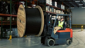 A Corning employee moves fiber cable through through Corning manufacturing facility in North Carolina A Corning employee moves fiber cable through through Corning manufacturing facility in North Carolina