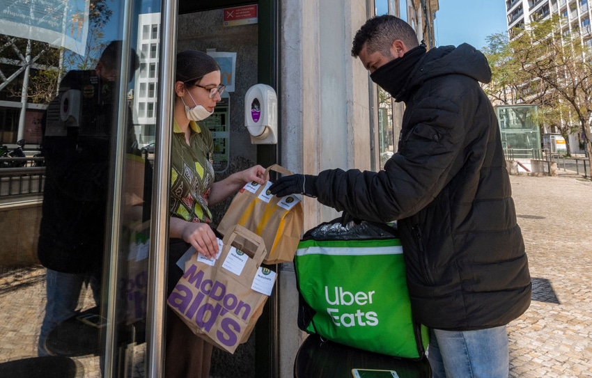 An Uber Eats driver picks up a food orders to be delivered at a McDonald's fast food restaurant on March 22, 2020 in Lisbon, Portugal.