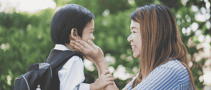 Mom and Her Child Smiling and Interacting in Natural Green Setting