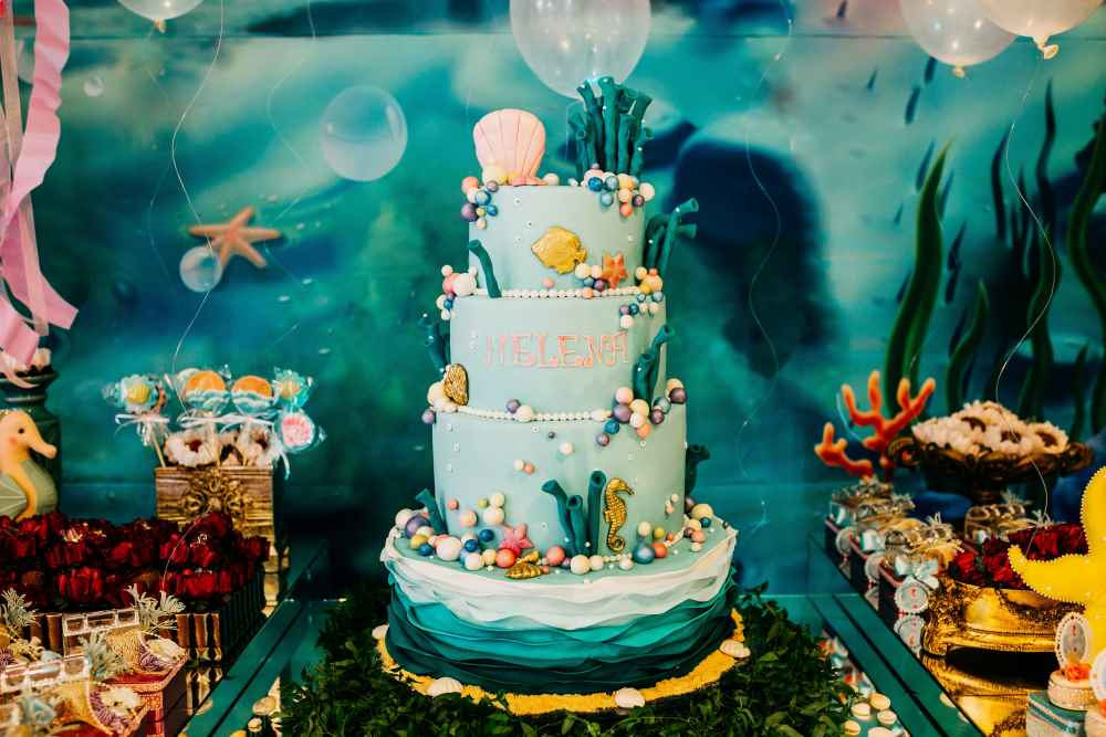 Four-Tier Sea-Themed Birthday Cake with Decorations and Name 'HELENA