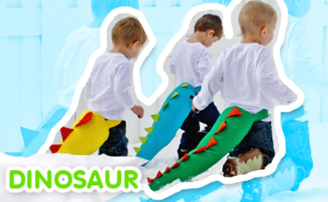 Three kids playing a dinosaur dress-up game.