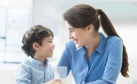 Mother and son smiling at each other