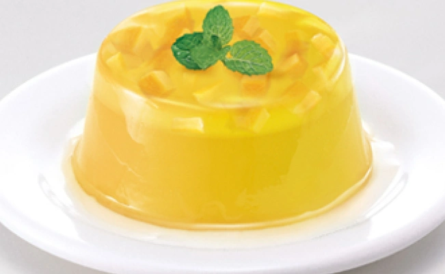 Mango jello dish served on white platter on white surface