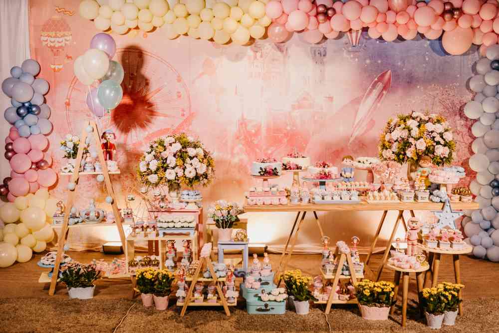 Dessert Table with Pink Balloon Arch and Floral Arrangements