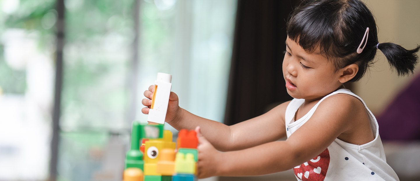 Young Girl Playing With Colorful Building Blocks