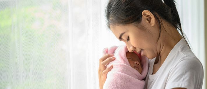 Baby being swaddled by the mother