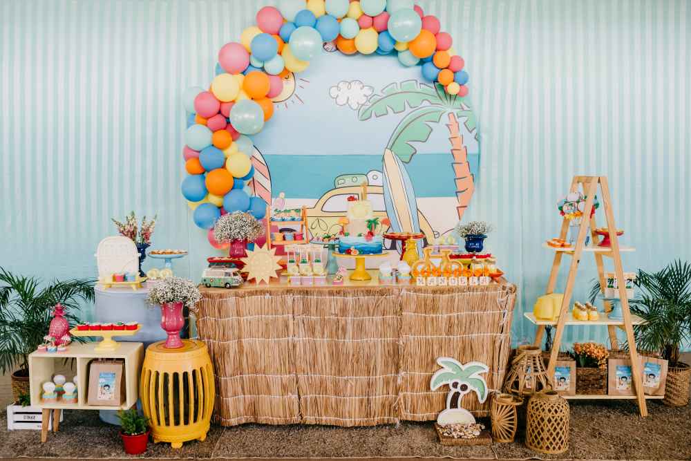 Beach-Themed Dessert Table with Light Blue Backdrop and Raffia Tablecloth