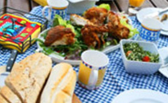 Picnic spread on a blue checkered tablecloth
