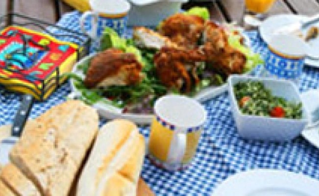 Picnic spread on a blue checkered tablecloth