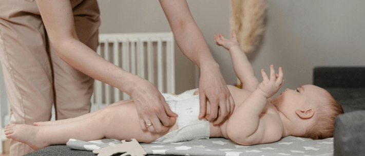 Mother Changing Diaper of Baby