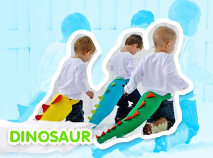 Three kids playing a dinosaur dress-up game.