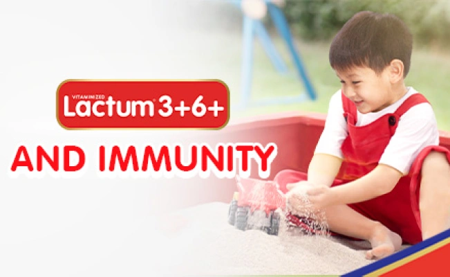 Lactum graphics with boy playing in sandbox.