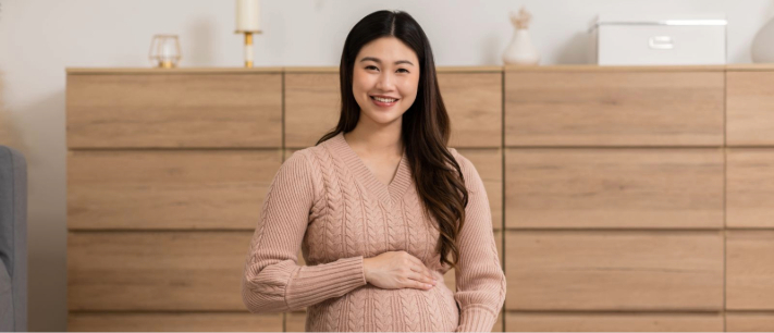 Pregnant woman sitting on rug
