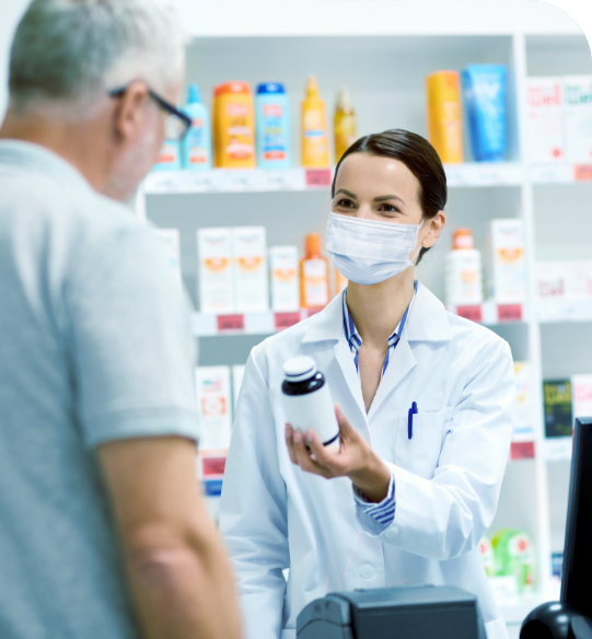A saleswoman gives the medicine to a man after the purchase A saleswoman gives the medicine to a man after the purchase